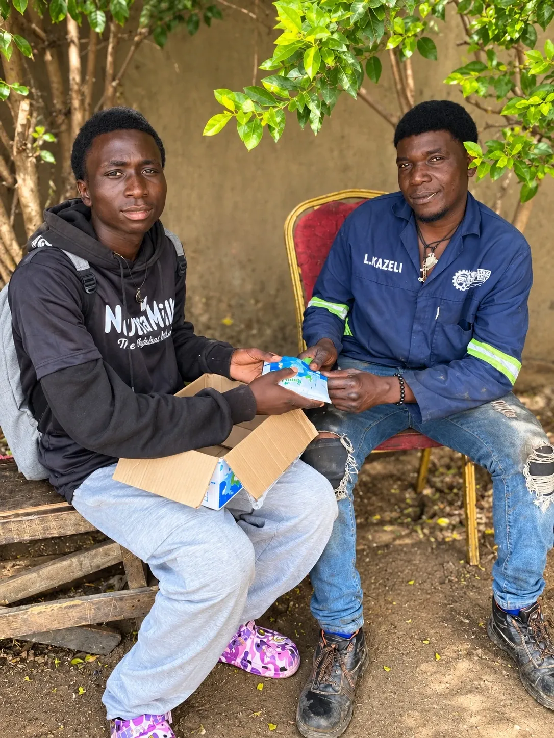 Brand ambassador handing Nutra Milk to a resident