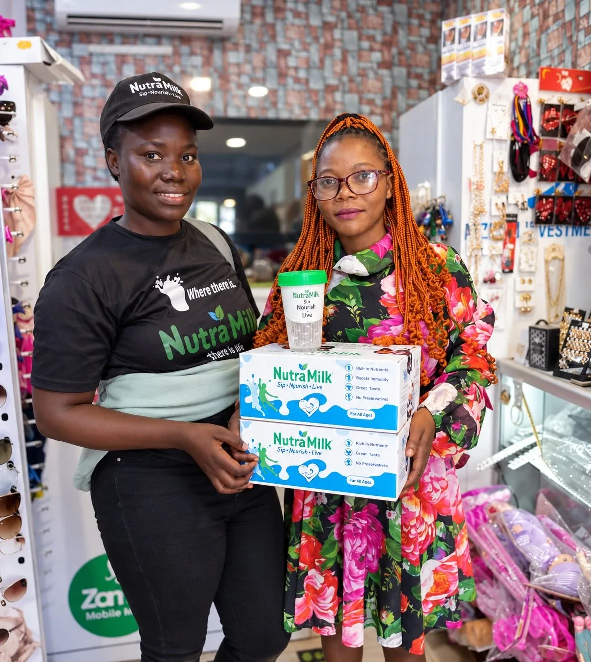 Brand ambassador with a shop owner holding Nutra Milk boxes